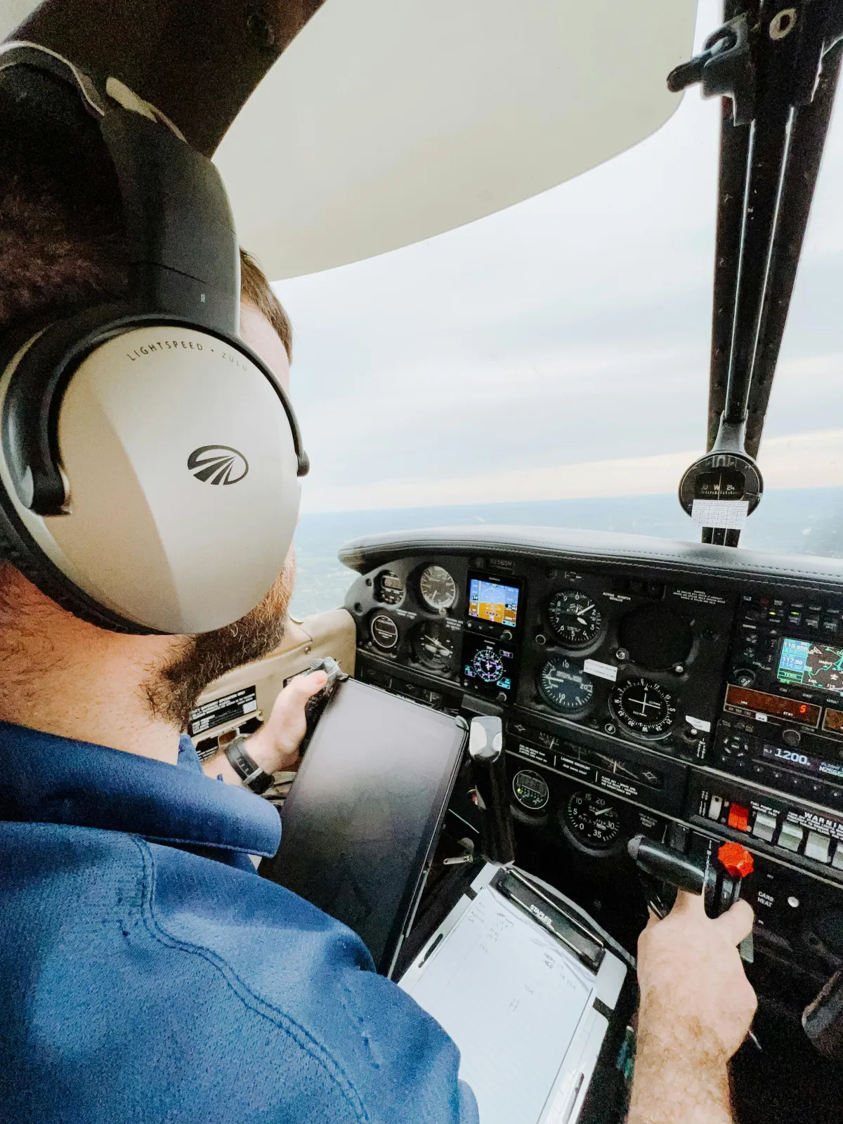 Pilote dans le cockpit portant un casque aviation pendant le vol